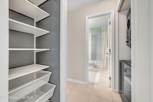 1600 Woodland Dr Unit 4206, Rockledge, FL 32955 - spacious closet with stacked washer / dryer and tile patterned floors