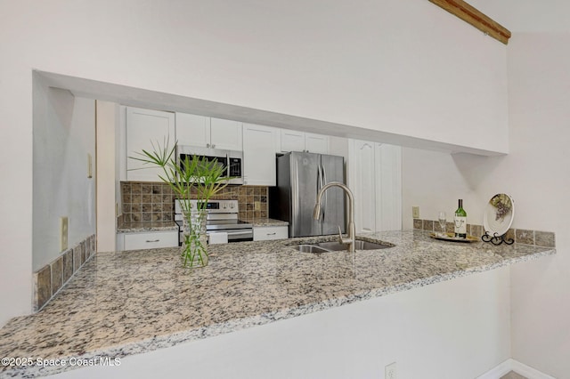 1600 Woodland Dr Unit 4206, Rockledge, FL 32955 - kitchen featuring appliances with stainless steel finishes, a peninsula, a sink, and decorative backsplash