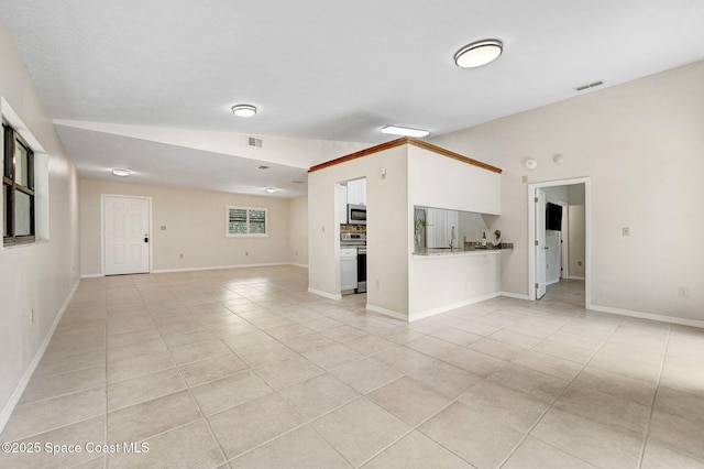 1600 Woodland Dr Unit 4206, Rockledge, FL 32955 - unfurnished living room with light tile patterned floors, lofted ceiling, and baseboards