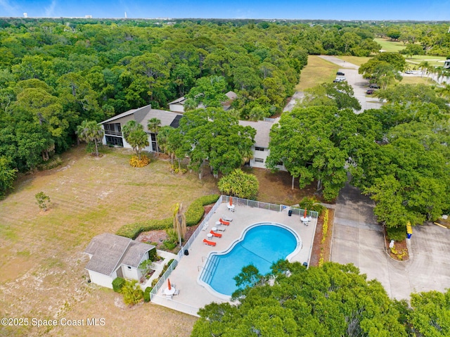 1600 Woodland Dr Unit 4206, Rockledge, FL 32955 - drone / aerial view of a pool area and a heavily wooded area