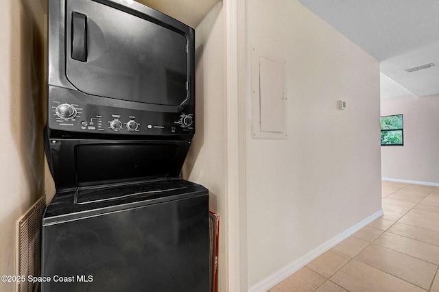 1600 Woodland Dr Unit 4206, Rockledge, FL 32955 - laundry area with stacked washer and clothes dryer, light tile patterned floors, electric panel, and baseboards