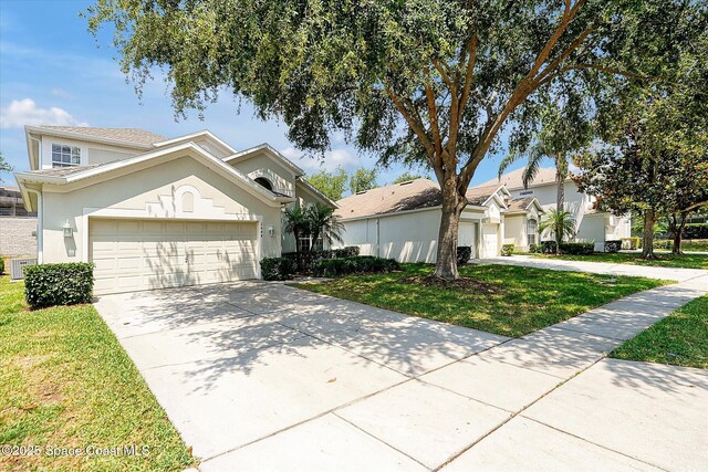 2648 Daulby St, Kissimmee, FL 34747 - view of front of house featuring stucco siding, concrete driveway, a garage, and a front lawn