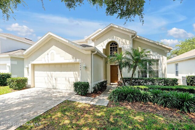 2648 Daulby St, Kissimmee, FL 34747 - view of front of property with a garage, stucco siding, and concrete driveway