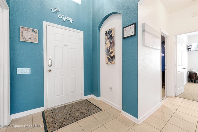 2648 Daulby St, Kissimmee, FL 34747 - entryway featuring tile patterned flooring, a textured wall, and baseboards