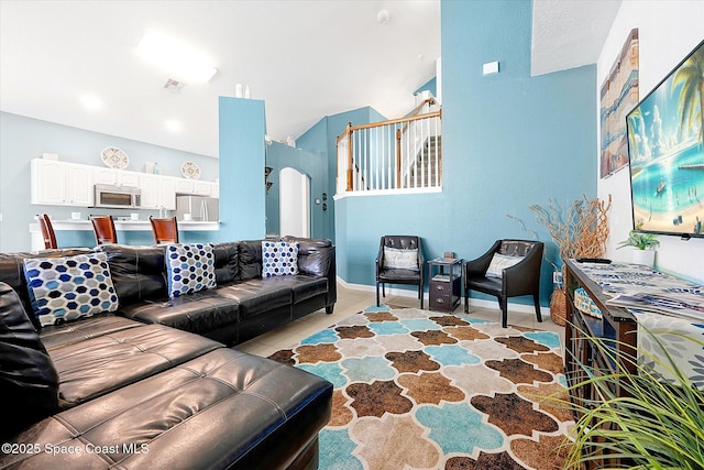 2648 Daulby St, Kissimmee, FL 34747 - living room featuring arched walkways and light tile patterned floors