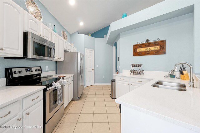 2648 Daulby St, Kissimmee, FL 34747 - kitchen featuring stainless steel appliances, a sink, light tile patterned flooring, and white cabinets