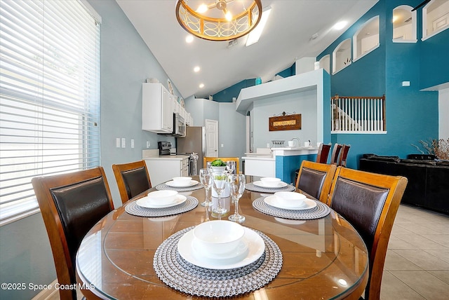 2648 Daulby St, Kissimmee, FL 34747 - dining room with light tile patterned flooring and high vaulted ceiling