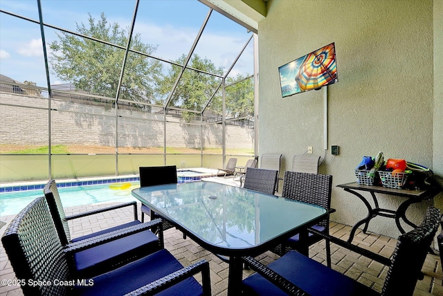 2648 Daulby St, Kissimmee, FL 34747 - view of patio / terrace with outdoor dining area, glass enclosure, an outdoor pool, and fence