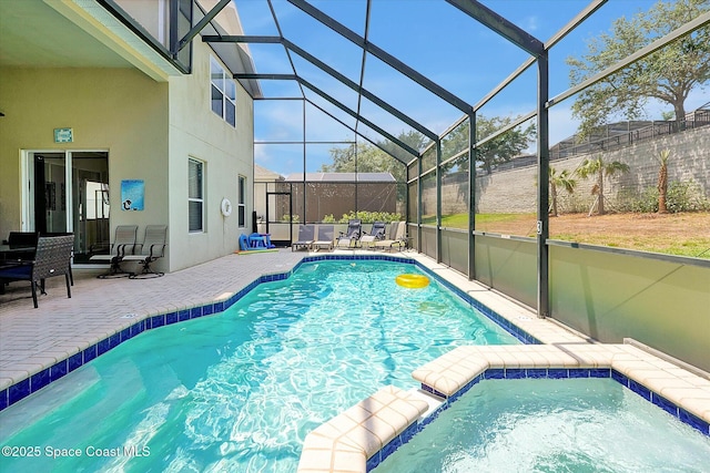 2648 Daulby St, Kissimmee, FL 34747 - view of pool with a patio area, glass enclosure, a pool with connected hot tub, and fence