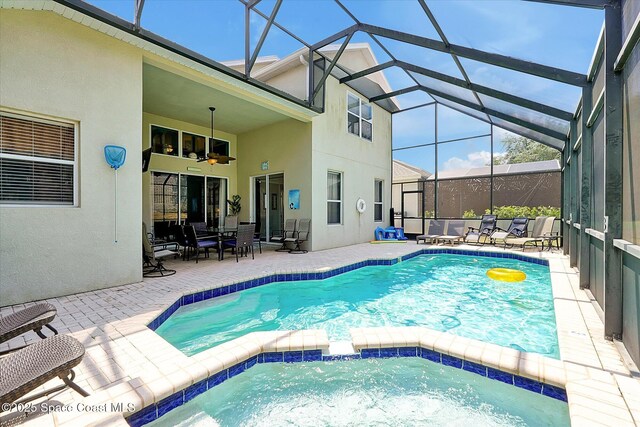 2648 Daulby St, Kissimmee, FL 34747 - view of swimming pool with ceiling fan, a patio area, a pool with connected hot tub, and glass enclosure