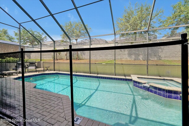 2648 Daulby St, Kissimmee, FL 34747 - view of swimming pool featuring a lanai, a patio area, and a pool with connected hot tub
