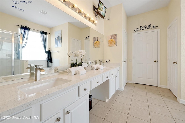 2648 Daulby St, Kissimmee, FL 34747 - full bath featuring tile patterned flooring, a stall shower, double vanity, and baseboards