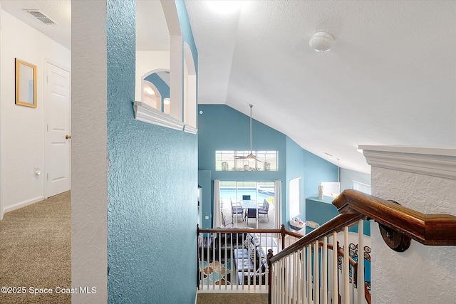 2648 Daulby St, Kissimmee, FL 34747 - hall featuring a textured wall, lofted ceiling, carpet, and an upstairs landing