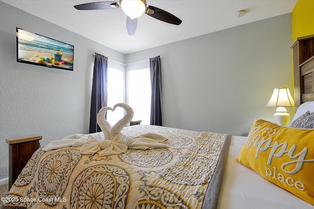 2648 Daulby St, Kissimmee, FL 34747 - bedroom featuring a textured wall and a ceiling fan