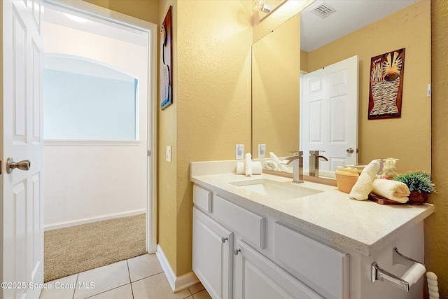 2648 Daulby St, Kissimmee, FL 34747 - bathroom featuring a textured wall, tile patterned floors, vanity, and baseboards