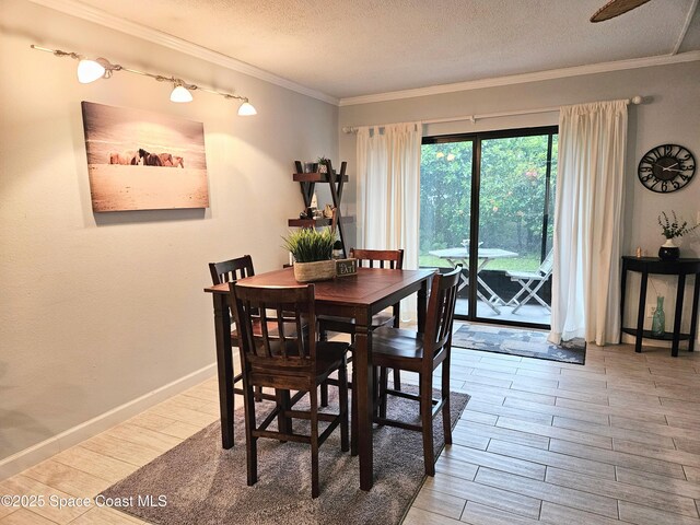 1700 S Atlantic Ave Unit 107, Cocoa Beach, FL 32931 - dining space featuring wood finished floors, a textured ceiling, crown molding, and baseboards