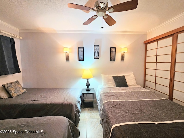 1700 S Atlantic Ave Unit 107, Cocoa Beach, FL 32931 - bedroom with crown molding, ceiling fan, and a textured ceiling
