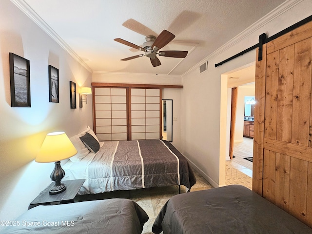 1700 S Atlantic Ave Unit 107, Cocoa Beach, FL 32931 - bedroom featuring ornamental molding, a barn door, baseboards, and a ceiling fan