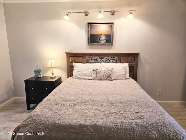 1700 S Atlantic Ave Unit 107, Cocoa Beach, FL 32931 - bedroom featuring wood finished floors and baseboards
