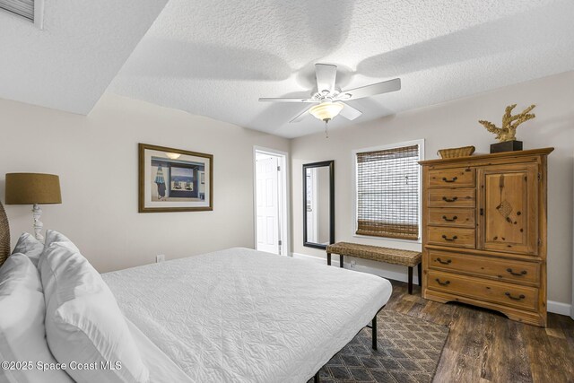 1145 S Atlantic Ave Unit B, Cocoa Beach, FL 32931 - bedroom featuring dark wood-style flooring, a textured ceiling, and ceiling fan