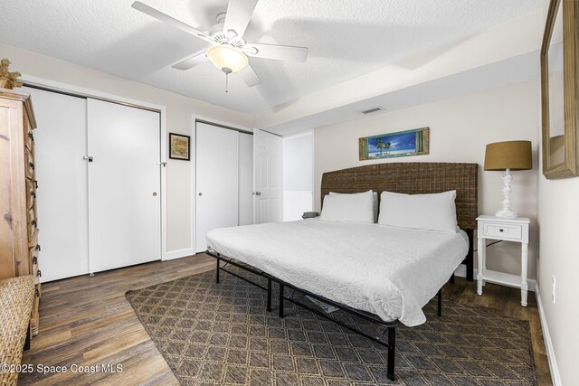 1145 S Atlantic Ave Unit B, Cocoa Beach, FL 32931 - bedroom with wood finished floors, multiple closets, a ceiling fan, and baseboards