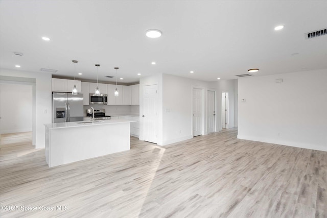 3258 Forghun Ave SE, Palm Bay, FL 32909 - unfurnished living room featuring a sink, recessed lighting, light wood-style flooring, and baseboards