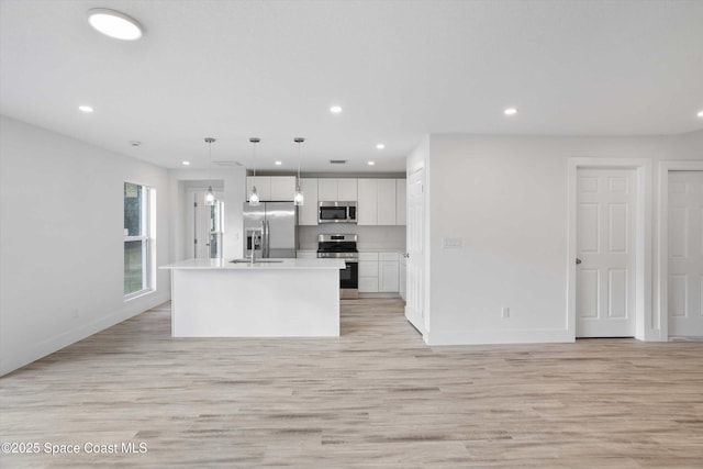 3258 Forghun Ave SE, Palm Bay, FL 32909 - kitchen with appliances with stainless steel finishes, recessed lighting, light wood-type flooring, white cabinets, and light countertops