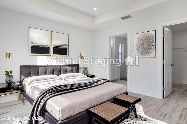 3258 Forghun Ave SE, Palm Bay, FL 32909 - bedroom featuring light wood finished floors, a walk in closet, recessed lighting, connected bathroom, and baseboards