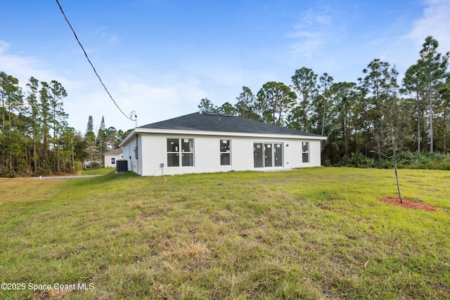 3258 Forghun Ave SE, Palm Bay, FL 32909 - rear view of house featuring stucco siding, a lawn, and central air condition unit