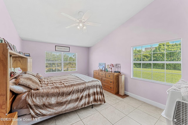 bedroom featuring vaulted ceiling, light tile patterned flooring, baseboards, and ceiling fan