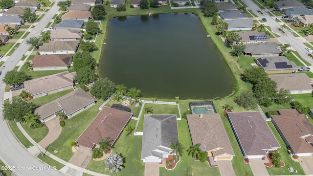 aerial view of property's location with a large body of water and nearby suburban area