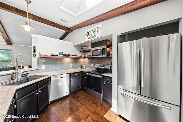 kitchen featuring stainless steel appliances, a sink, tasteful backsplash, and light countertops