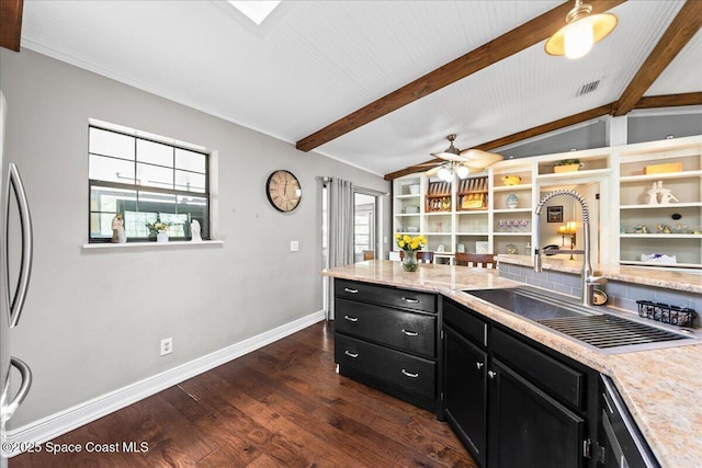 kitchen featuring dark cabinets, a sink, healthy amount of natural light, and dark wood finished floors