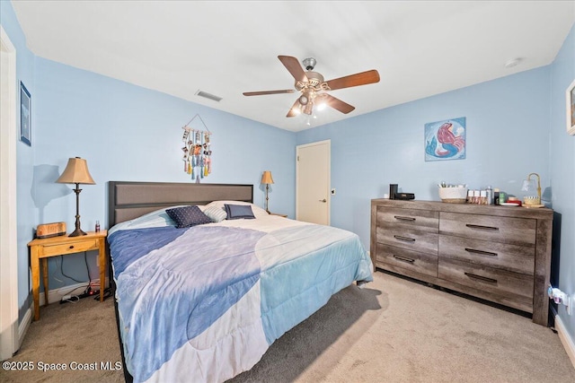 carpeted bedroom featuring a ceiling fan and baseboards