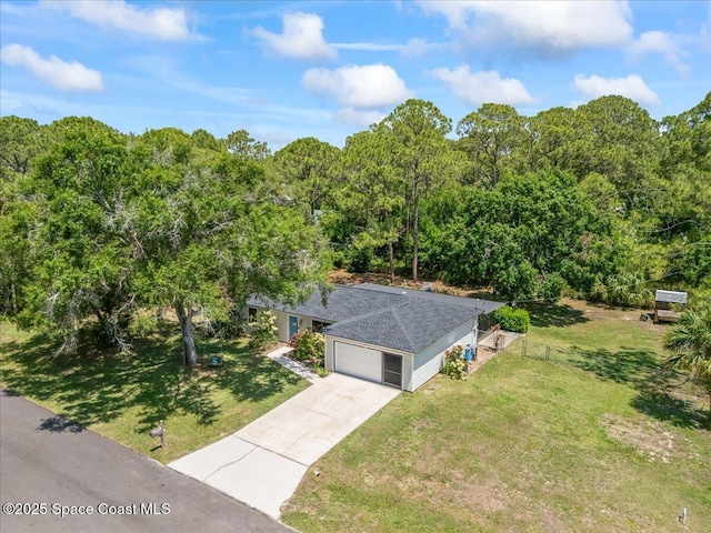 aerial view of property and surrounding area with a forest