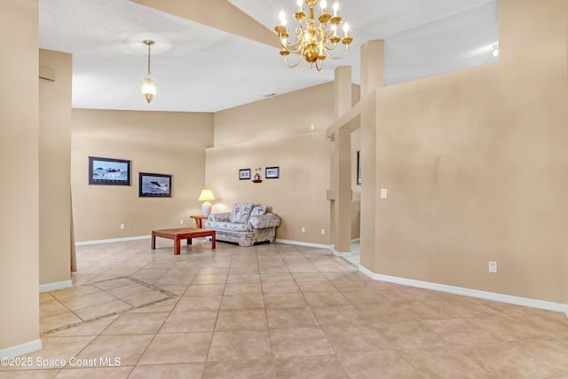 2805 Forest Run Dr, Melbourne, FL 32935 - living room with a chandelier, light tile patterned floors, baseboards, and high vaulted ceiling