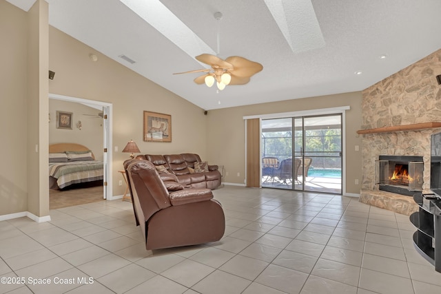 2805 Forest Run Dr, Melbourne, FL 32935 - living room with light tile patterned floors, ceiling fan, lofted ceiling, a stone fireplace, and baseboards