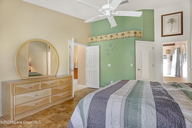 2805 Forest Run Dr, Melbourne, FL 32935 - bedroom featuring a towering ceiling, ceiling fan, and light stone finish floors