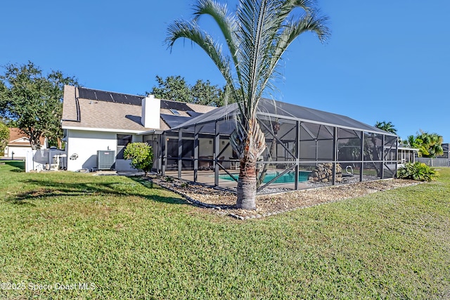 2805 Forest Run Dr, Melbourne, FL 32935 - back of property with an outdoor pool, a lawn, central air condition unit, and a chimney