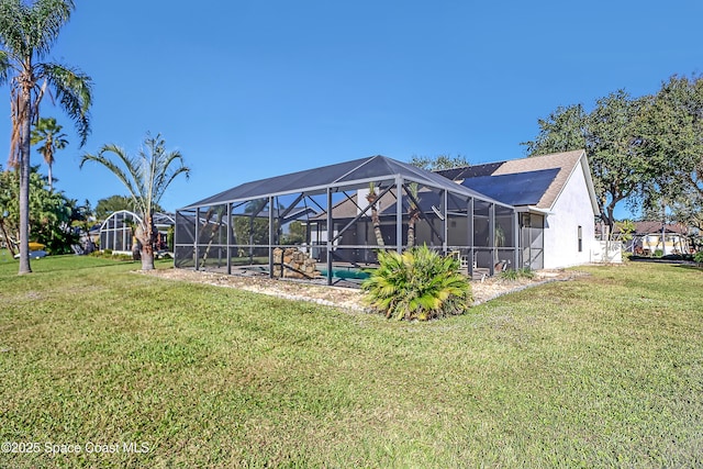 2805 Forest Run Dr, Melbourne, FL 32935 - rear view of house with a yard, stucco siding, and a lanai