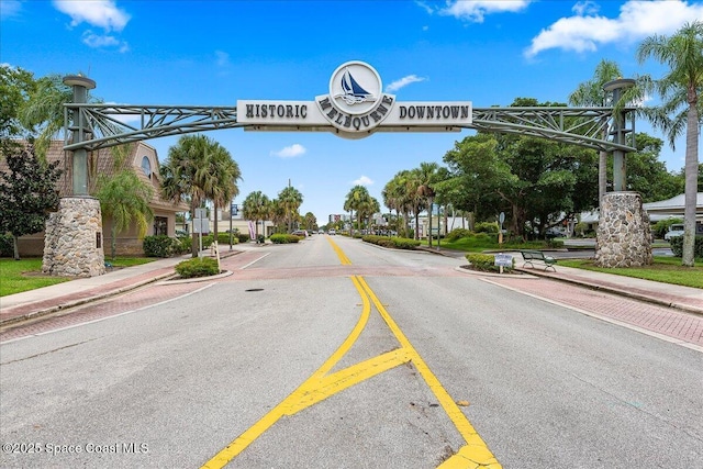 view of asphalt street with sidewalks and curbs