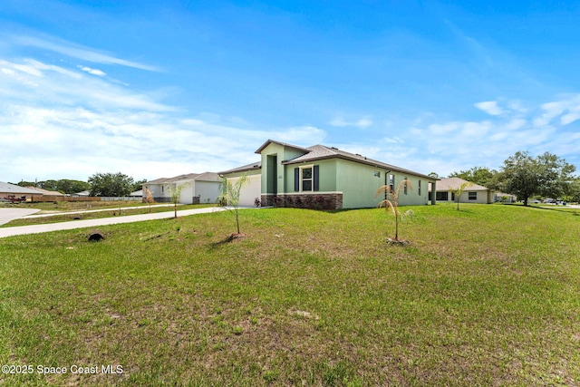 view of front of property with concrete driveway, a garage, and a front yard