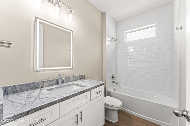 full bath with wood finished floors, toilet, shower / bathtub combination, and vanity