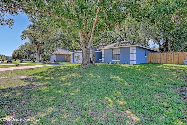 690 Koutnik Rd SE, Palm Bay, FL 32909 - view of front of home with stucco siding, driveway, and an attached garage