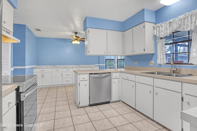 690 Koutnik Rd SE, Palm Bay, FL 32909 - kitchen featuring stainless steel appliances, a sink, a ceiling fan, light countertops, and a textured ceiling