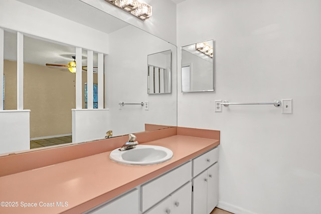 690 Koutnik Rd SE, Palm Bay, FL 32909 - bathroom with a ceiling fan, vanity, and baseboards
