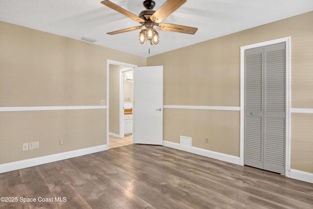 690 Koutnik Rd SE, Palm Bay, FL 32909 - unfurnished bedroom with baseboards, light wood-type flooring, a closet, and ceiling fan
