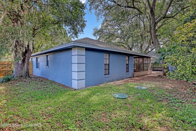 690 Koutnik Rd SE, Palm Bay, FL 32909 - view of side of property featuring stucco siding and a sunroom