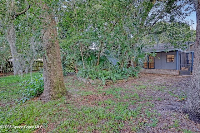 690 Koutnik Rd SE, Palm Bay, FL 32909 - view of yard with a sunroom and fence