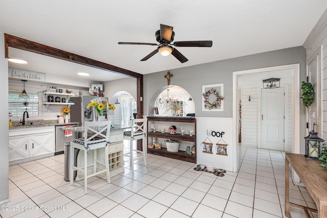 958 Beaumont Ln, Rockledge, FL 32955 - kitchen with open shelves, ceiling fan, a sink, wainscoting, and white cabinetry